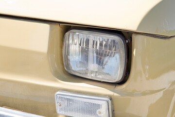Detail of an headlight of a vintage italian sport car
