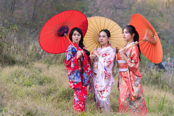 Where will the girl go. Attractive asian woman wearing kimono and sakura flowers. Asian beauty skin care woman looking at side.
