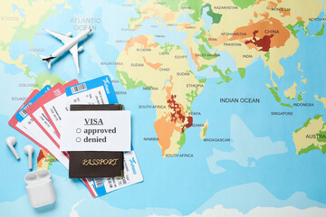 Flat lay composition with passport and tickets on world map. Space for text
