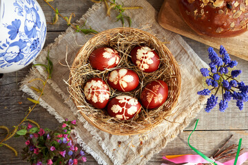 Easter eggs in a basket with mazanec - sweet Easter pastry similar to hot cross bun