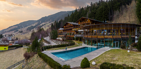 Beautiful view of naturhotel leitlhof and mountains against sky during sunset