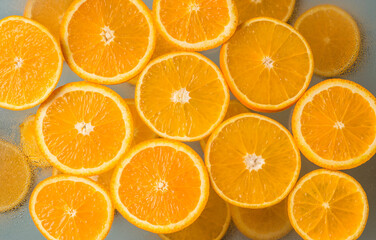 Juicy citrus fruits. Orange slices on a light background. Top view. Healthy natural product.