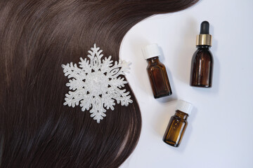 Obraz premium Close-up oil bottle and recovery hair. Concept hairdresser spa salon. hair restoration and treatment after winter. Curl female hair, balm or hair mask isolated on white background.