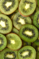 Sliced kiwi fruit as a green background