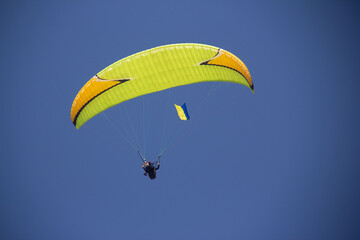 Paragliding with sunset , parachute with amazing sky with Ukrainian flag, Ukraine support