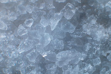 Coarse white iodized salt. Detailed background texture Macro close-up. Salt crystals of different sizes