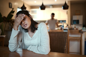I need to get out. Shot of a woman looking stressed while sitting at home with her boyfriend...