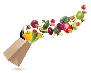 Kraft paper bag with different fruits and vegetables on white background