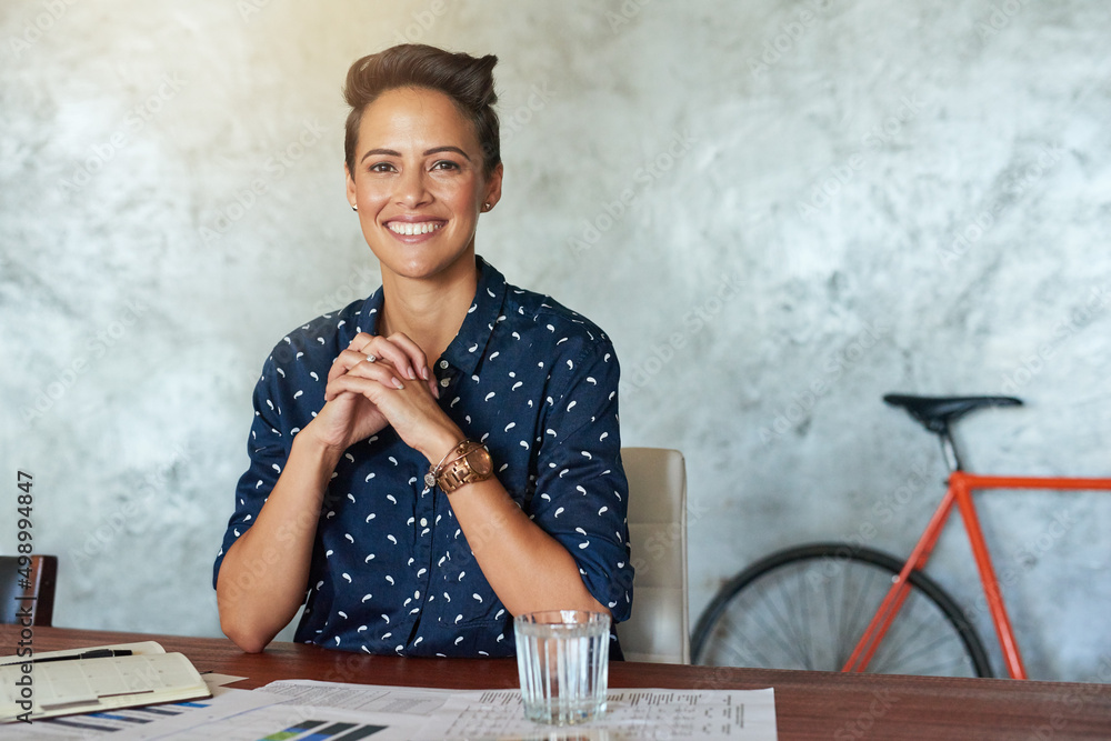 Poster confidence is key in running a business. portrait of a creative employee in a modern office.
