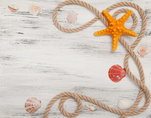 Fototapeta na wymiar Nautical background with ropes, shells and starfish