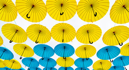 Fototapeta na wymiar Umbrella street decoration bottom-up sky background