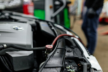 Professional car mechanic servicing car air conditioner. Car repair shop.