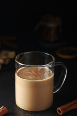 A cup with masala chai in low key	