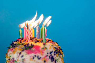 birthday cake with candles on a colorful background