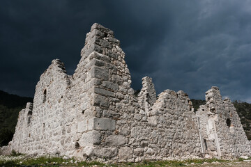 Ruins of antic Olympos against a stormy dramatic sky. Turkey.
