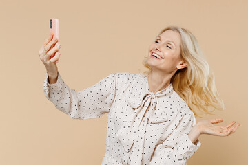 Vivid happy elderly gray-haired blonde woman lady 40s years old wears pink dress doing selfie shot...