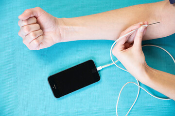 Close-up of a woman's arm giving herself an injection.
