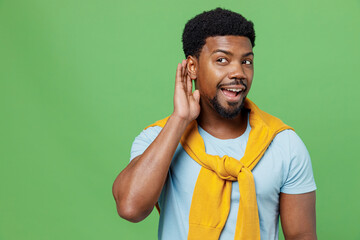 Young curious nosy fun man of African American ethnicity 20s wear blue t-shirt try to hear you...