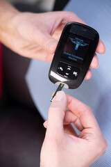 Close-up of the hands of a diabetic woman a tab into a to measure.