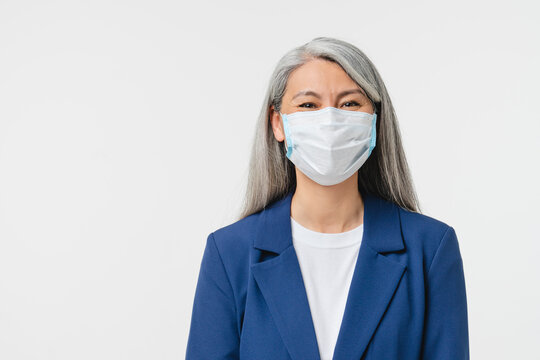 Pandemic, Social Distance, Isolation Concept. Caucasian Mature Middle-aged Businesswoman Teacher Bank Manager Wearing Protective Face Mask Against Coronavirus Isolated In White Background