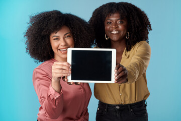 Fire up the wifi, youre going to want to download this. Studio shot of two young women holding a...