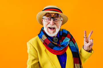 Cool senior man with fashionable outfit portrait - Funny old male person with cool and playful attitude on colorful background - obrazy, fototapety, plakaty