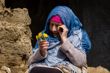 Woman in tears because of the war. Ukrainian woman near a destroyed house during the war. War in...