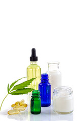 Hemp leaf with bottle of essential oils.
