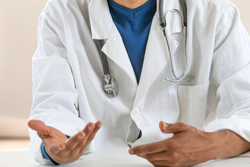 Doctor consultation: close up of doctor explaining to patient.