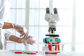 Electron microscope and test tubes containing blood in a laboratory.