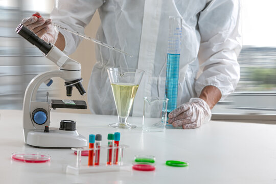 Laboratory worker doing research with laboratory glassware surrounded.