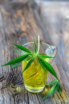 Close-up of a hemp sprig on top of a glass cup.