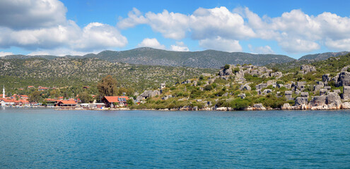 Fototapeta premium Panoramic view of ancient Lycian Simena town and modern Uchagiz village on sunny day. Simena, Turkey.