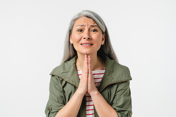 Begging mature poor middle-aged caucasian woman asking for help, assistance, praying to God for...