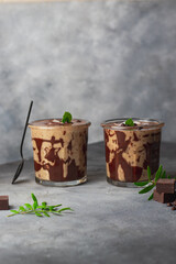 banana smoothie with coconut milk and coconut, decorated by chocolate and mint leafes