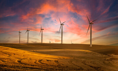 Wind generators in Sherman County Oregon wheat country are shown against a sunrise sky.    Located...