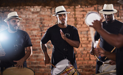 Filling the evening with their awesome beats. Shot of a group of musical performers playing together.