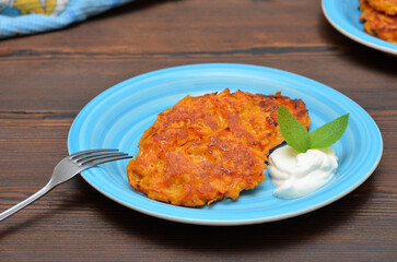 tasty breakfast pumpkin pancakes with cream on a plate