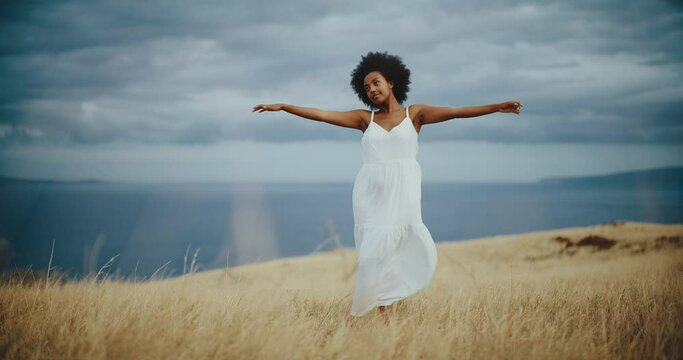 Lifestyle portrait of beautiful young black african american woman in golden field