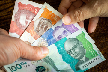 Colombian money, Lots of Pesos banknotes handed over to another person
