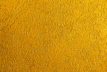 Golden wall with abstract spots as a background. Beautiful golden texture with patterns, decorative...