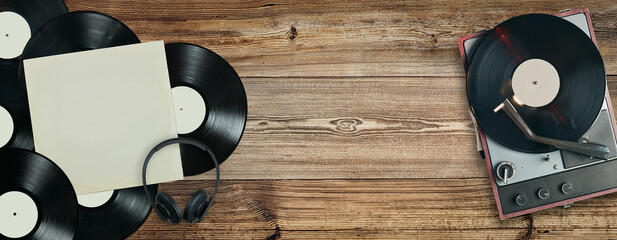 Vinyl records and turntable player on old wooden background. Records collection. Music vintage...