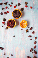  jerked cherry with   dry dog rose and hawthorn,  anise  around blue wooden background . Christmas background. flat lay