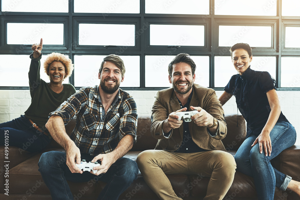 Aufkleber Switch things up at the office. Shot of a group of designers having fun while playing games.