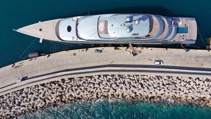 Aerial drone top down photo of luxury yacht anchored in Mediterranean port