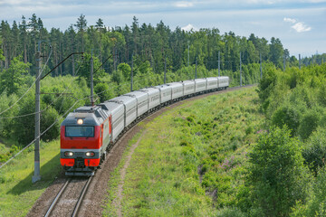 Naklejka premium Passenger train moves at summer morning time.