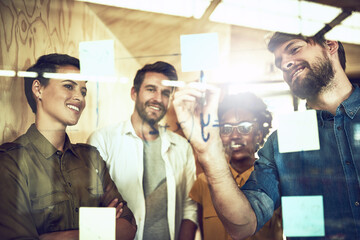 Theres no problem too hard for them to solve. Shot of a group of businesspeople brainstorming with...