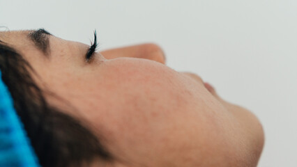 Face of a woman in a beauty spa on white background.