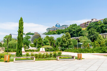 Scenic beautiful view panorama of old historic city Tbilisi center, large tubes of Rike park, architecture building, Georgia in summer sunny day, nature bright landscape