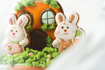 Gingerbread cookies in the shape of cute Easter bunny decorated with festive icing on the white background